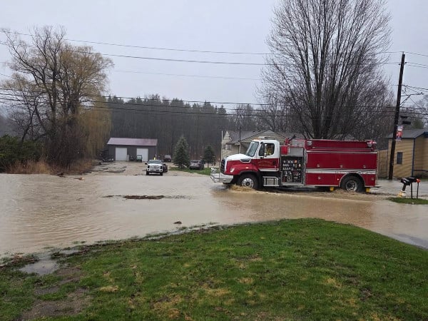 A Prattsburgh fire truck drives through floodwaters in a residential area of Prattsburgh, NY.